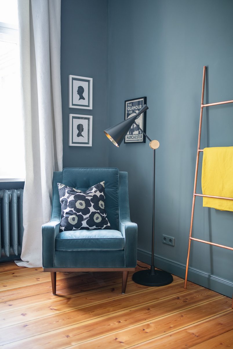 Inchyra blue walls and sanded wooded floorboards with blue armchair and Tom Dixon floorlamp