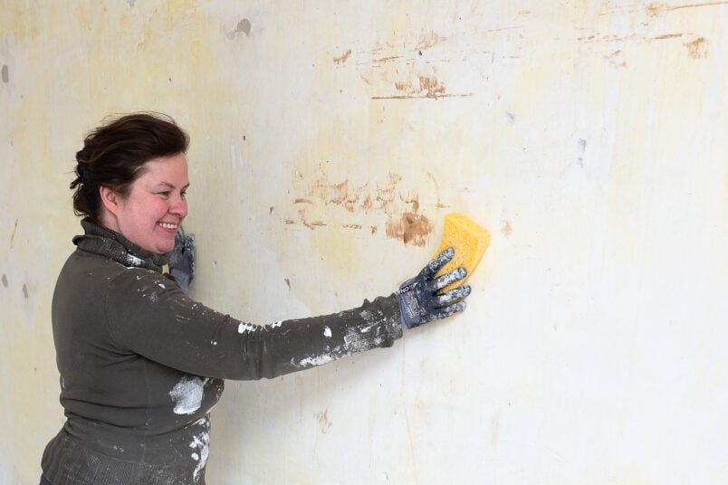 cleaning wall with sponge