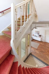 staircase with faded red carpet