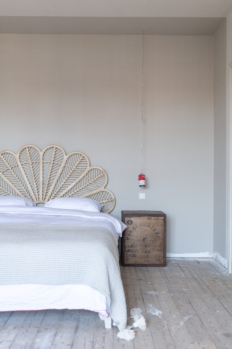 Bedroom with brown walls and rattan headboard and tea chest bedside cabinets