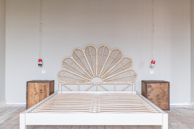 bed with rattan headboard and tea chest bedside tables
