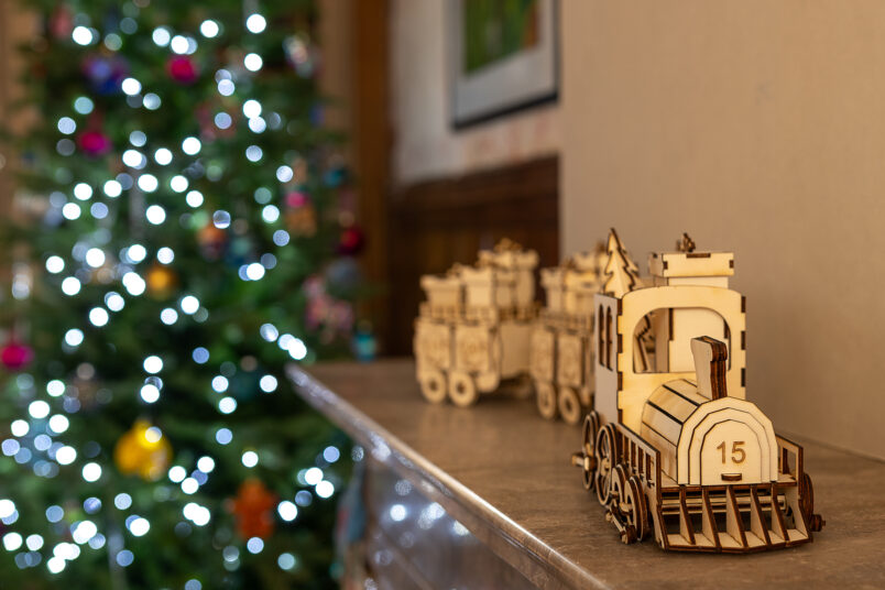 lasercut advent calendar train on fireplace mantel
