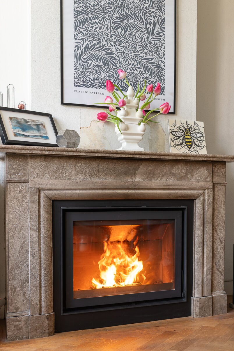 Barbas Bellfires Wood Burning Stove built into existing marble fireplace surround